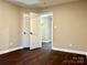 Bedroom with hardwood floors and access to hallway and closet at 7915 Willows Pond Ct, Charlotte, NC 28277