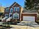 Two-story brick home with attached garage and manicured landscaping at 7915 Willows Pond Ct, Charlotte, NC 28277