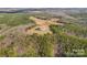 Aerial view of house nestled on a large wooded lot at 590 Tuckertown Rd, New London, NC 28127