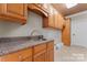 Well-equipped laundry room with ample cabinetry and a utility sink at 590 Tuckertown Rd, New London, NC 28127