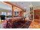 Game room with a pool table, adjacent to a living area at 590 Tuckertown Rd, New London, NC 28127