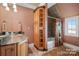 Well-appointed bathroom with a shower/tub combo and built-in storage at 590 Tuckertown Rd, New London, NC 28127