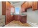Bright laundry room with ample cabinetry and slate tile flooring at 590 Tuckertown Rd, New London, NC 28127