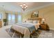 Large main bedroom with plush bed, scenic window views and calming decor at 590 Tuckertown Rd, New London, NC 28127