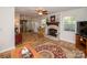 Open living room and kitchen area with a fireplace and hardwood flooring at 10933 Hunter Trail Ln, Charlotte, NC 28226