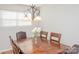 Bright dining room features a wood table with leather chairs and a modern chandelier at 10933 Hunter Trail Ln, Charlotte, NC 28226