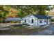 Newly constructed home with white siding, dark roofing, and a welcoming front porch at 205 W Robinson St, Dallas, NC 28034