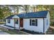 Newly built home with white siding, red door, and black shutters at 205 W Robinson St, Dallas, NC 28034