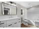 Modern bathroom with white vanity, bathtub, and stylish mirror at 205 W Robinson St, Dallas, NC 28034