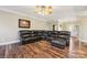 Spacious living room featuring a large sectional sofa and hardwood floors at 4225 Cheshire Glen Dr, Monroe, NC 28110