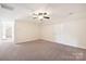 Empty carpeted bedroom with neutral walls and a ceiling fan at 4225 Cheshire Glen Dr, Monroe, NC 28110