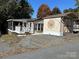 Property view showing home, deck, and storage shed at 104 Cardinal Ave, New London, NC 28127