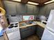 Small kitchen with gray cabinets and white appliances at 104 Cardinal Ave, New London, NC 28127