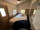 Main bedroom with a double bed and full-length mirror at 104 Cardinal Ave, New London, NC 28127