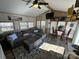 Open living room with sectional sofa and wood floors at 104 Cardinal Ave, New London, NC 28127