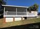 Home exterior showcasing a large screened porch and deck at 104 Cardinal Ave, New London, NC 28127