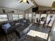Cozy living room featuring a sectional sofa, coffee table, and wood-look floors at 104 Cardinal Ave, New London, NC 28127
