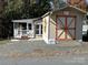 Property view showing home, deck, and storage shed at 104 Cardinal Ave, New London, NC 28127