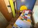 Small bedroom with twin bed and painted sun accent wall at 104 Cardinal Ave, New London, NC 28127