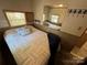 Bright bedroom with a double bed and mirrored wall at 104 Cardinal Ave, New London, NC 28127