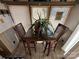 Small dining area with glass-top table and four chairs at 104 Cardinal Ave, New London, NC 28127