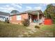Brick ranch home with a covered porch and storage shed at 131 E Branch Ave, Shelby, NC 28152