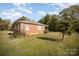 Brick ranch home with a yard and a tree in front at 131 E Branch Ave, Shelby, NC 28152