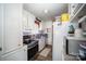 Efficient galley kitchen with white cabinets and stainless steel appliances at 131 E Branch Ave, Shelby, NC 28152