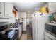 Galley kitchen with white cabinets, stainless steel appliances, and view to dining area at 131 E Branch Ave, Shelby, NC 28152