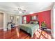 Spacious bedroom with red accent wall, hardwood floors and ceiling fan at 235 Dashers Den None, Fort Mill, SC 29708