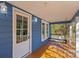 Inviting front porch with a white door and swing at 480 Wyatt Grove Church Rd, Gold Hill, NC 28071