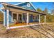 Blue house with a large front porch and yard at 480 Wyatt Grove Church Rd, Gold Hill, NC 28071