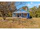 Charming blue house with a spacious front porch at 480 Wyatt Grove Church Rd, Gold Hill, NC 28071