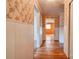 Long hallway with wood floors and floral wallpaper at 2926 Englewood Dr, Shelby, NC 28150