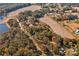 Aerial view showing home nestled in trees near a pond at 2926 Englewood Dr, Shelby, NC 28150