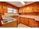 Kitchen offers wood cabinets, tiled countertops, and stainless steel sink at 2926 Englewood Dr, Shelby, NC 28150
