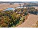 Aerial view showcasing home, pond, and surrounding fields at 2926 Englewood Dr, Shelby, NC 28150