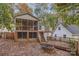 Elevated deck with stairs leading to backyard and screened porch at 118 Taylor Ct, Mooresville, NC 28117