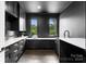 Modern laundry room with dark cabinetry and quartz countertops at 2105 La Gorce Dr, Charlotte, NC 28226