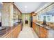 Long kitchen with granite countertops and wood cabinets at 29049 Snapper Pt, Tega Cay, SC 29708