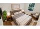 Virtually staged bedroom with hardwood floors and large window at 2614 Bancroft St, Charlotte, NC 28206