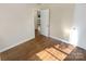 Well-lit bedroom with hardwood floors and access to other rooms at 2614 Bancroft St, Charlotte, NC 28206
