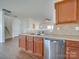 Kitchen with double sinks, stainless steel dishwasher, and wood cabinets at 620 Smokehouse Ln, Albemarle, NC 28001