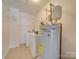 Laundry room with washer, dryer, and water heater at 620 Smokehouse Ln, Albemarle, NC 28001
