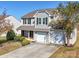 Two-story house with gray siding, two-car garage, and landscaping at 620 Smokehouse Ln, Albemarle, NC 28001