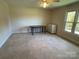 Bedroom with window, carpet, and small table and dresser at 103 Berea Baptist Church Rd, Stanfield, NC 28163