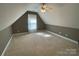 Bright attic bedroom with carpet, window, and ceiling fan at 103 Berea Baptist Church Rd, Stanfield, NC 28163