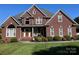 Brick house with a two-car garage, a welcoming porch, and manicured lawn at 103 Berea Baptist Church Rd, Stanfield, NC 28163