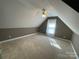 Charming attic bedroom with window, carpet, and ceiling fan at 103 Berea Baptist Church Rd, Stanfield, NC 28163
