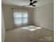 Bright bedroom featuring carpet, ceiling fan, and window with curtains at 103 Berea Baptist Church Rd, Stanfield, NC 28163